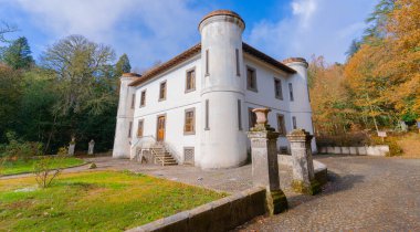 Majestic villa Piercy with white walls surrounded by autumn foliage in Sardinia clipart