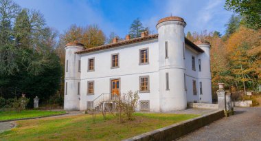 Majestic villa Piercy with white walls surrounded by autumn foliage in Sardinia clipart