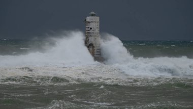 Powerful waves crashing against a Mangiabarche lighthouse during a hurricane, symbolizing resilience and the forces of nature clipart