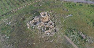 Majestic ruins of nuraghe Piscu in sardinia, italy, stand tall against a vibrant blue sky clipart