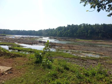 Landscape view of river get dry near waterfall and blue sky and green trees