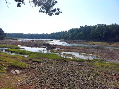 Landscape view of river get dry near waterfall and blue sky and green trees