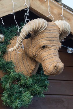 İsa Mesih 'in doğuşunu kutlamak için ahşap bir kulübede asılı duran sığır dolması Noel süslemesi.                               