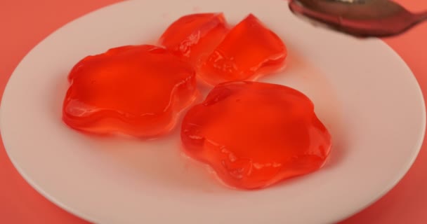 Wobbly Jelly Hitting Spoon Berry Gelatin Jelly Plate Pink Background — Stock Video