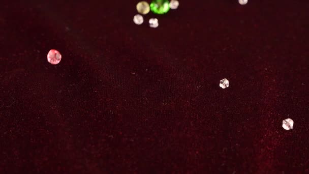 Multi Colored Transparent Jewelry Crystals Fall Burgundy Velvet Slow Motion — Stock video