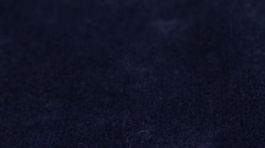 Transparent white jewelry crystals, rock crystal and pearls fall on blue velvet.