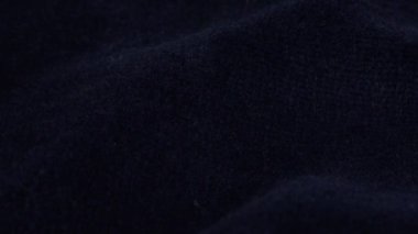 Transparent white jewelry crystals, rock crystal and pearls fall on dark blue velvet.