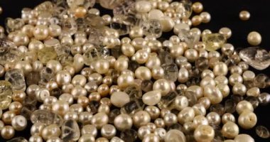 Natural pearls, quartz, rock crystal on black velvet.