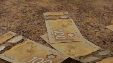 Falling Canadian 100 dollar polymer banknotes with a portrait of Robert Borden. Slow motion.