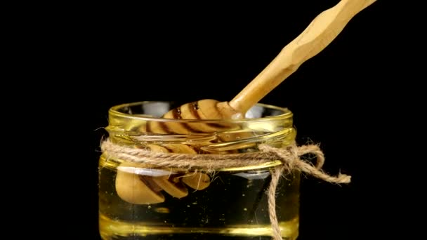 Honey Flows Spoon Spindle Jar Honey Black Background — Stockvideo