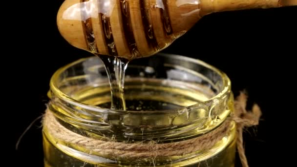 Honey Flows Spoon Spindle Jar Honey Black Background — Stockvideo