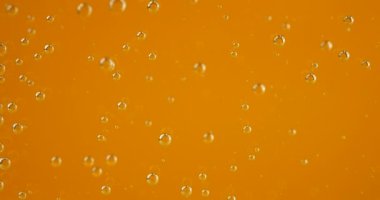 Air bubbles on an orange background.
