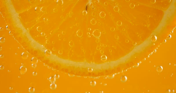 Slice Ripe Orange Water Bubbles Orange Background — Stock video