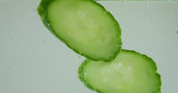 Falling Fresh Cucumber Slices Air Bubbles — Stockvideo