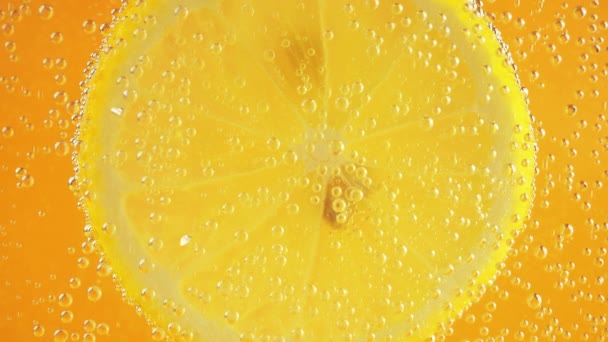 Шматочок Стиглого Лимона Повітряних Бульбашках Помаранчевому Фоні — стокове відео