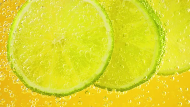 Ripe Lime Slices Air Bubbles Orange Background — Vídeo de Stock