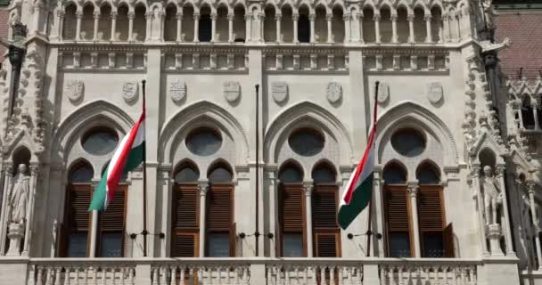 Ungerska Parlamentsbyggnaden Nygotisk Stil Och Ungerska Flaggorna Fladdrar Vinden Budapest — Stockvideo