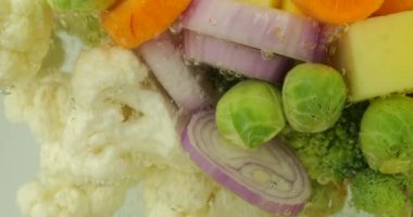 Kaynar suda hava kabarcıklarıyla çorba yapmak için sebze karışımı..