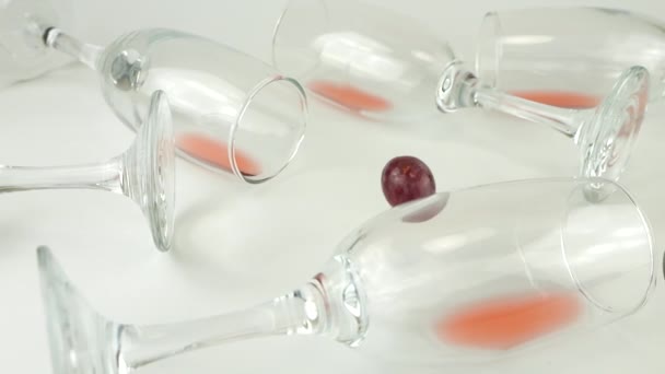 Trauben Fallen Auf Gläser Mit Rotwein Auf Weißem Grund Zeitlupe — Stockvideo