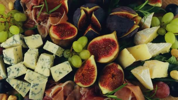 Figs Jamon Spinach Leaves Grapes Nuts Blue Cheeses Wooden Board — Stock Video
