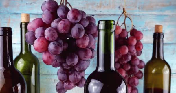 蓝色复古木制背景的粉红葡萄和酒瓶 — 图库视频影像