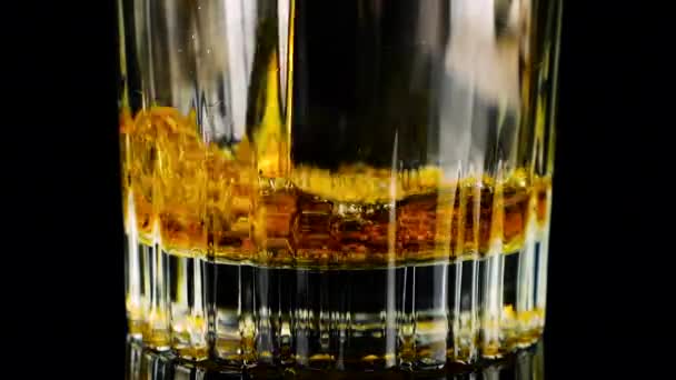 ウイスキーはグラスに注ぎ込まれています スローモーション — ストック動画
