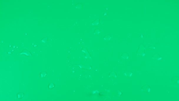 Druppels Water Vallen Een Groene Achtergrond — Stockvideo