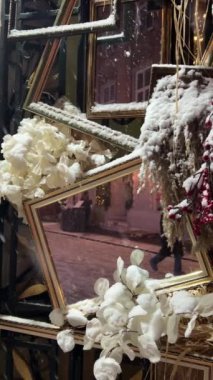 Decorative elements and decorations of the entrance to the souvenir shop. Winter, it's snowing. Vertical video.