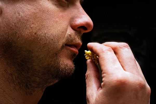 profile of a man eating popcorn