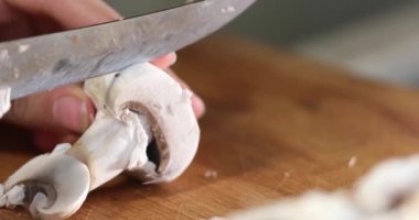 cut thin slices of champignon on a cutting board with a sharp knife. To cook