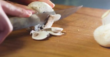 cut porcini mushrooms thinly with a knife on a cutting board. To cook