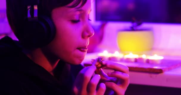 Happy Boy Headphones Puts Last Piece Chocolate Donut His Mouth — Vídeos de Stock