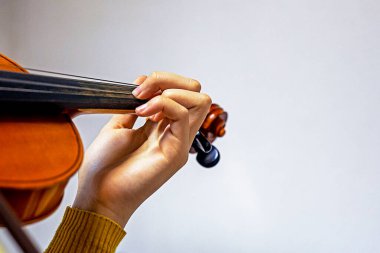 training the left hand on the strings on the student's violin. Musical education
