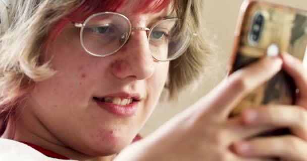 Ευτυχισμένο Έφηβο Κορίτσι Ροζ Μαλλιά Και Γυαλιά Παίζει Στο Τηλέφωνο — Αρχείο Βίντεο