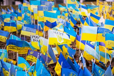 blue-yellow flags of Ukraine with a trident as a symbol of those who died in the war between Ukraine and Russia. horizontal