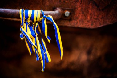 blue-yellow Ukrainian ribbons as a symbol tied to parts of military equipment. War with Ukraine