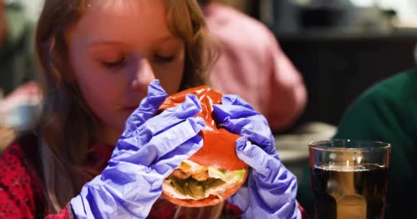 Little Girl Pleasure Disposable Gloves Bites Huge Burger Horizontal — Stock Video
