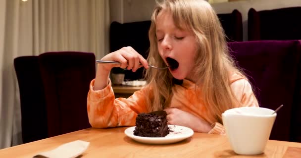 Girl Long Blond Hair Eats Chocolate Cake Fork Modern Interior — Stock Video