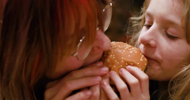 Happy Funny Two Girls Bite Small Burger Two Sides Horizontal — Stock Video