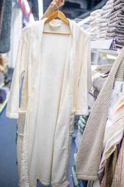 Denemek için beyaz bornozu mağazadaki askıda tut. Satın almalar