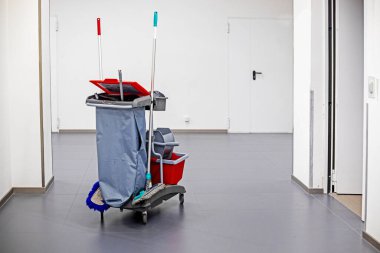 Classic cleaning trolley. Broom, bucket, detergents, cleaning products in public places, hotels, supermarkets, airports, toilets clipart