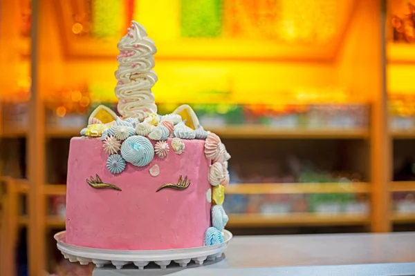 beautiful cake in the idea of a pink unicorn for a children\'s party. Family holiday