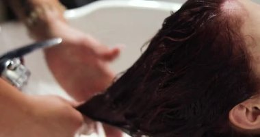 Duşta barbekü yapan kişi saçını kesmeden önce yıkar. saç bakımı ve bakım
