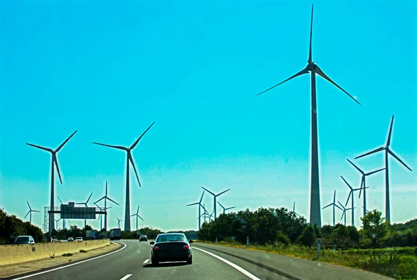 windmills along the autobahn on a sunny day. Smart Energy Use