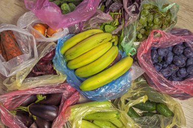 yeşil muzlar diğer sebzelerin ve meyvelerin üzerinde çok renkli plastik poşetlerde bulunur. Düz çizgi