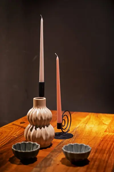 decorative candles on the table with candle holders
