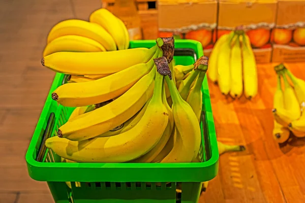 basket full of banana bunches in a grocery basket in a supermarket