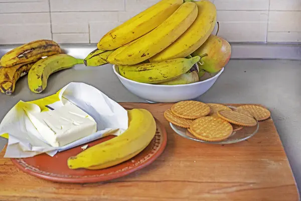 frozen butter with banana cookies and banana on a wooden cutting board. flatlay
