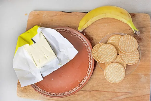 frozen butter with banana cookies and banana on a wooden cutting board. flatlay