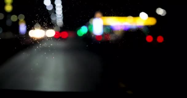 Blurred Red Green Yellow Lights Car Headlights Windshield Rain Wet — Stock Video